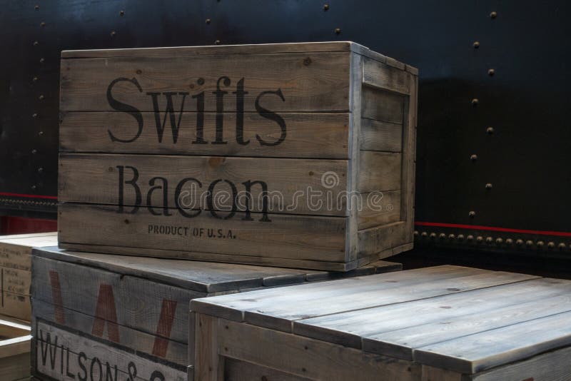 Russia, Saint-Petersburg, 30 May 2018: Old Wooden boxes in the warehouse. Crates for packing Swift Bacon. Pile of stacked. Delivery, cargo, logistic and transportation storage concept. Russia, Saint-Petersburg, 30 May 2018: Old Wooden boxes in the warehouse. Crates for packing Swift Bacon. Pile of stacked. Delivery, cargo, logistic and transportation storage concept.