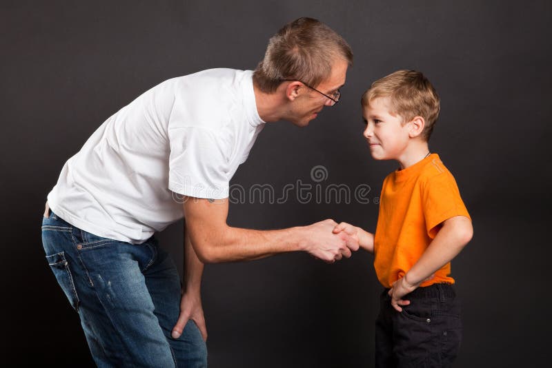 Father shakes hands with the son. Father shakes hands with the son