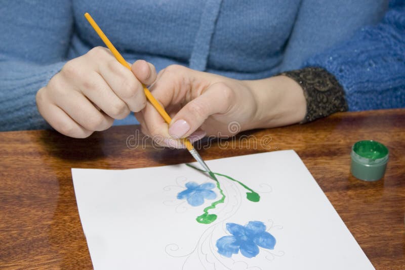 Tutor is helping for disabled person to paint. Tutor is helping for disabled person to paint