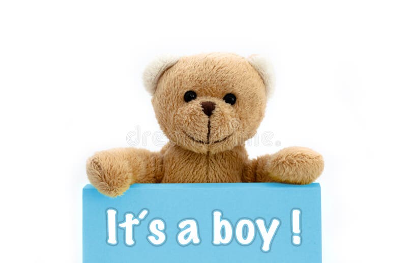 Boy baby shower ItÂ´s a boy message written on blue card with brown teddy bear holding with the two hands the note with the