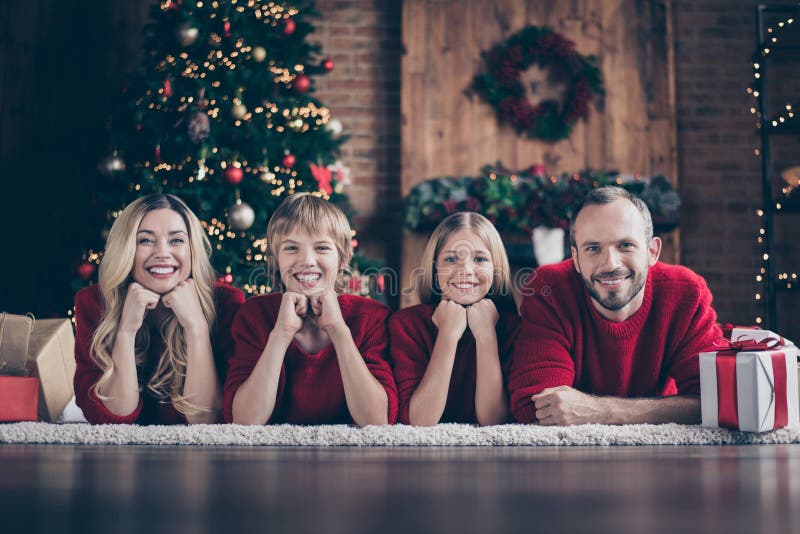 It`s christmas time.Photo of dad mom sister brother spending x-mas eve together in harmony lying floor near garland