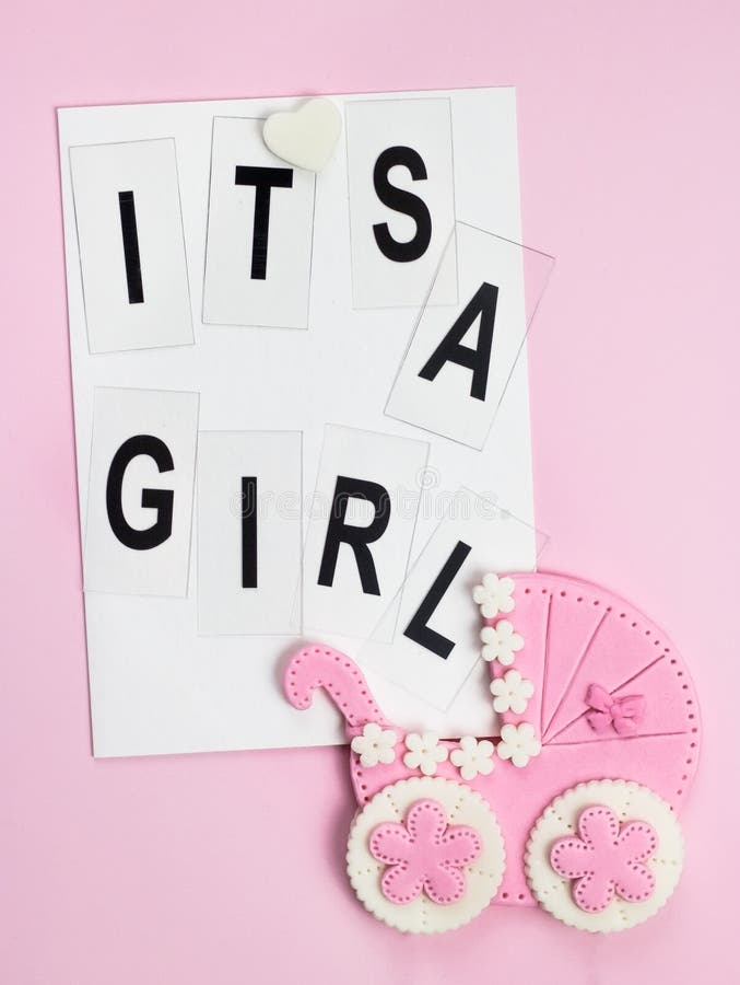 It`s a girl pink card. Newborn background. Baby shower invitation. Baby announcement. Fondant baby accessories. Flat lay. It`s a girl pink card. Newborn background. Baby shower invitation. Baby announcement. Fondant baby accessories. Flat lay