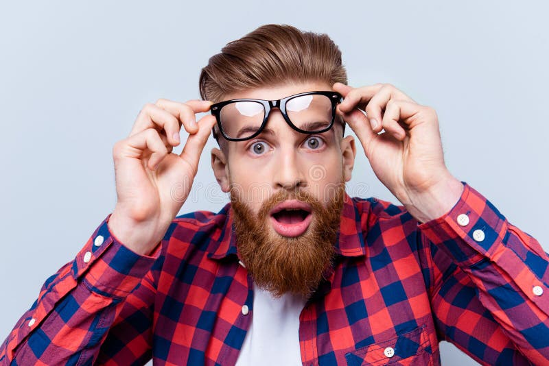 It`s incredible! Close up portrait of young bearded man touching