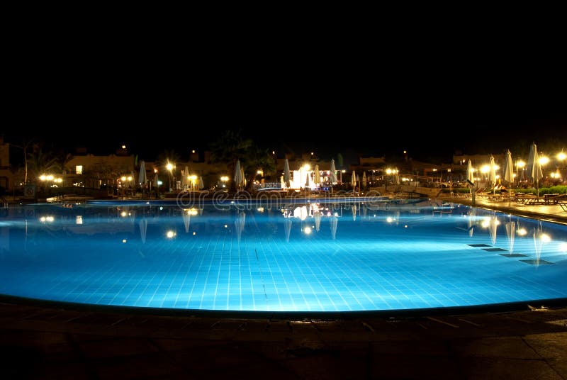 Swimming pool by night in a luxury hotel. Swimming pool by night in a luxury hotel