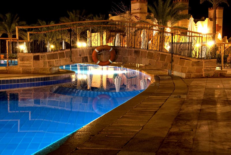 Swimming pool by night in a luxury hotel. Swimming pool by night in a luxury hotel