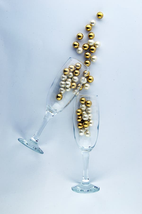 It`s party time! Two champagne glasses with sparkling decorations.