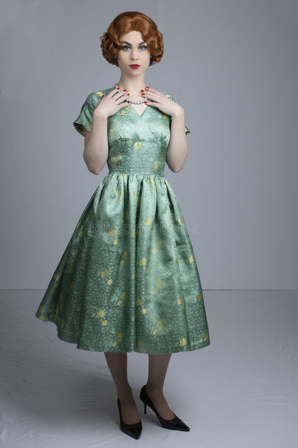 1950`s woman in green satin dress