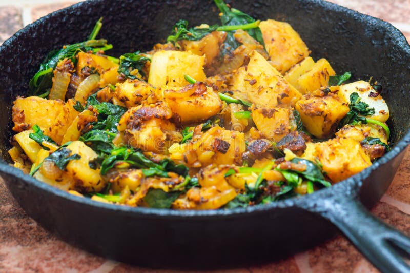 Saag Aloo, Indian Style Spinach and Potatoes in Cast Iron Pan Stock