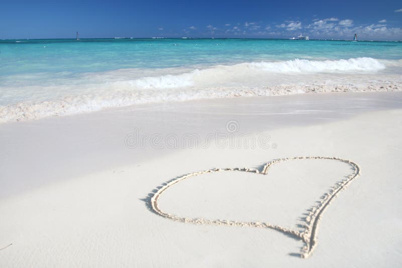 Beautiful Caribbean tropical beach with a big heart drawn on white sand and green ocean, suitable background for a variety of traveling and holiday/love designs. Beautiful Caribbean tropical beach with a big heart drawn on white sand and green ocean, suitable background for a variety of traveling and holiday/love designs