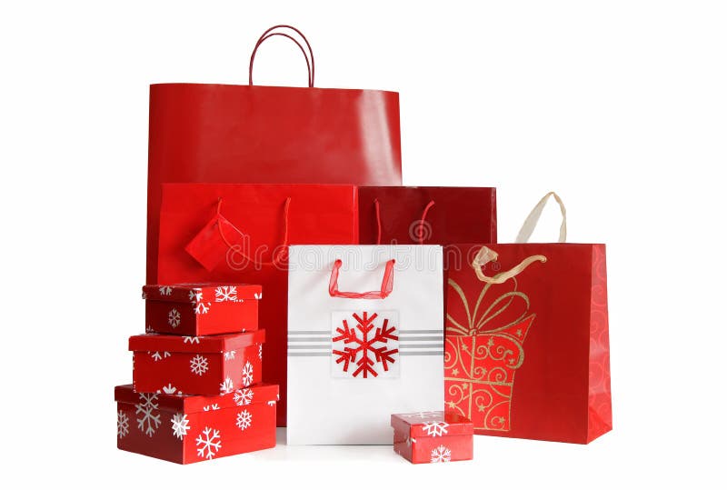 Sacchetti di shopping di festa e contenitori di regalo su bianco
