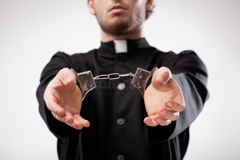 Young christian priest in cassock arrested and handcuffed. Young christian priest in cassock arrested and handcuffed