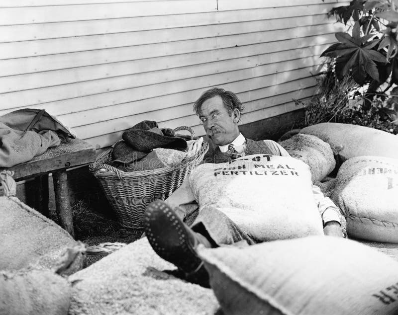 Sack Fallen Onto a Man Throwing Him Down To the Floor Stock Image