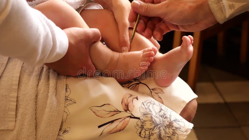 The sacrament of baptism. Newborn baby during christening.