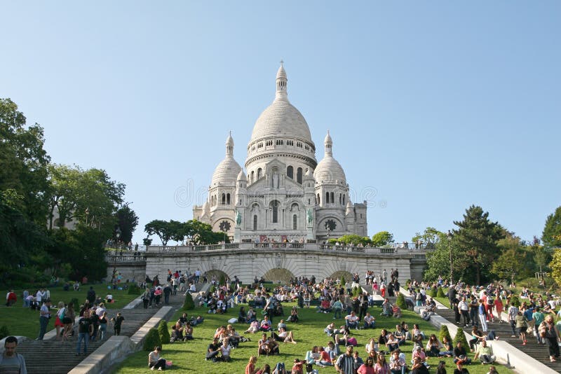 Sacre Coeur Basilica. People relax near Sacre Coeur Basilica - One of the most famous symbol of Paris. Paris, June 15, 2014 stock image Sacre Coeur Basilica. People relax near Sacre Coeur Basilica - One of the most famous symbol of Paris. Paris, June 15, 2014 stock image