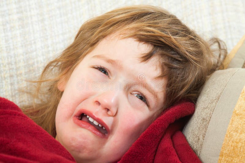 Sad baby lying stock images