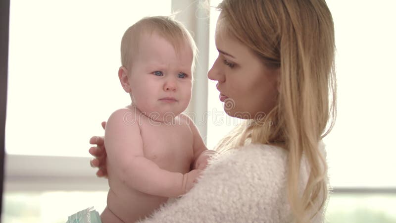 Sad Baby on Mom Hands. Young Mother Holding Infant Kid on Embrace Stock Video - Video of daughter, human: 116918733