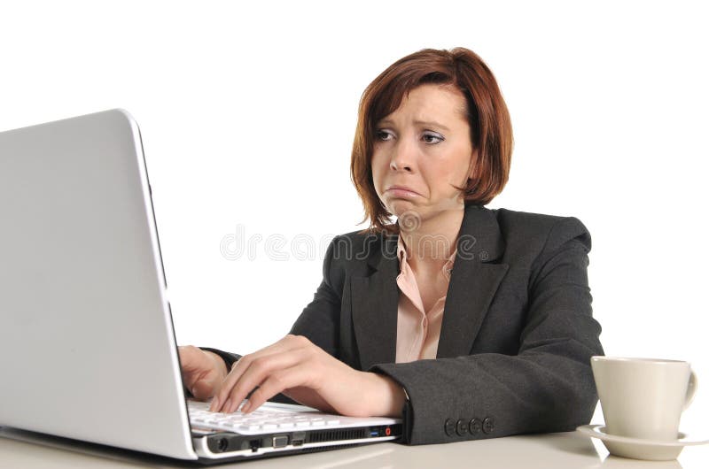 Sad business red haired woman in stress at work with computer