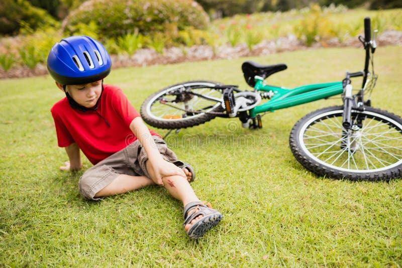 Sad child falling from his bike royalty free stock photography Sad child falling from his bike royalty free stock photography