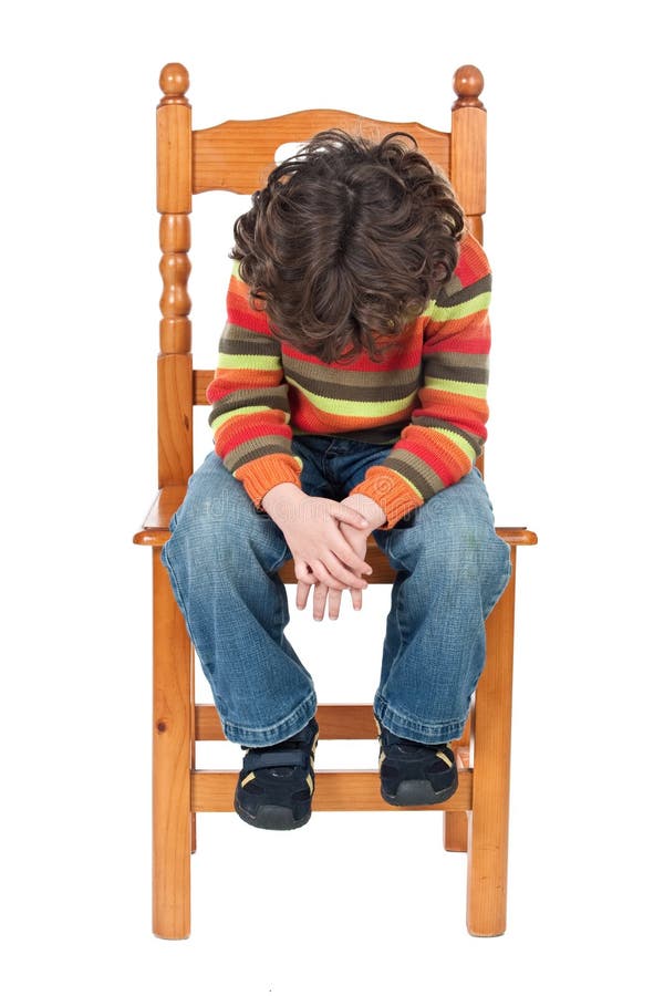 Sad child sitting on a chair isolated