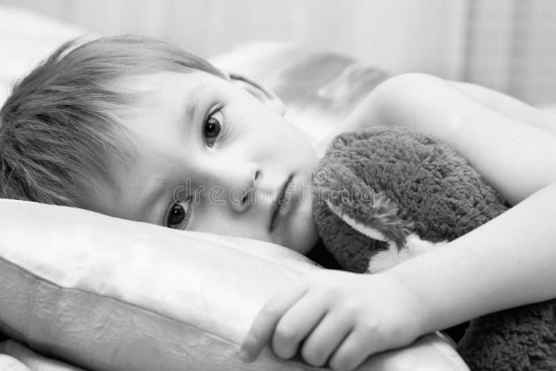 Sad child with a teddy bear