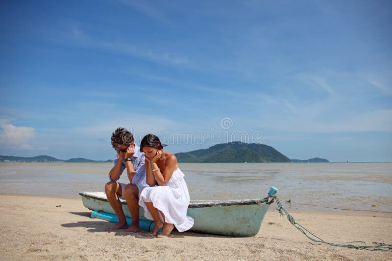 Sad couple on beach