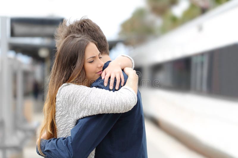 Sad couple saying goodbye before travel