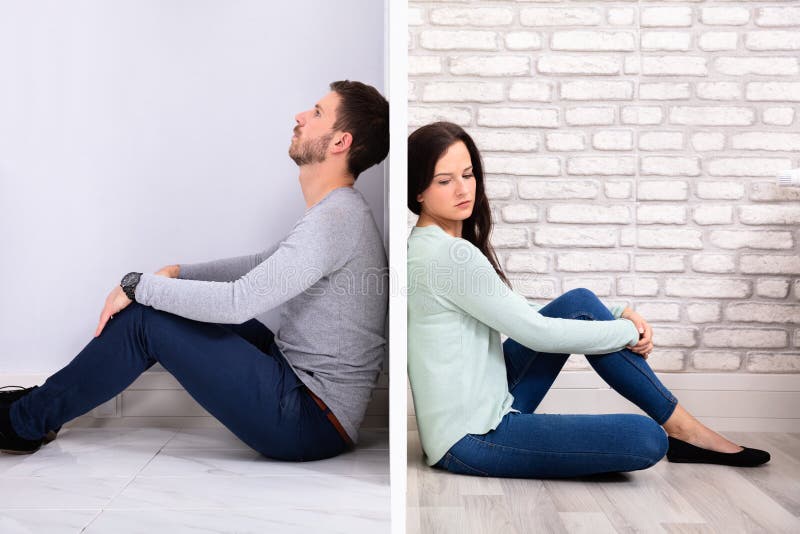 Sad Couple Sitting On Floor royalty free stock images Sad Couple Sitting On Floor royalty free stock images