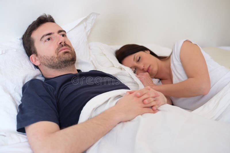 Sad and Depressed Man in the Bed with His Wife Stock Photo picture