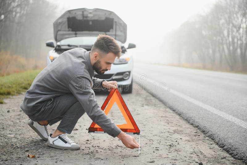Sad Driver Having Engine Problem Standing Near Broken Car on the Road
