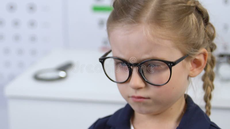 Sad female kid wearing eyeglasses prescribed doctor, child insecurities, frame