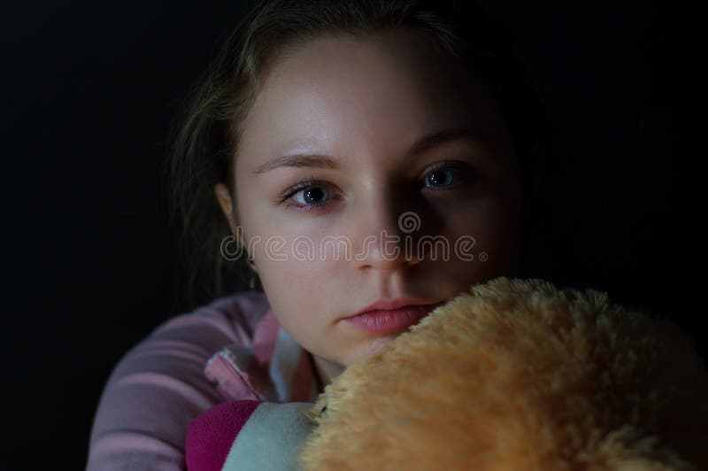 The sad girl on a dark background