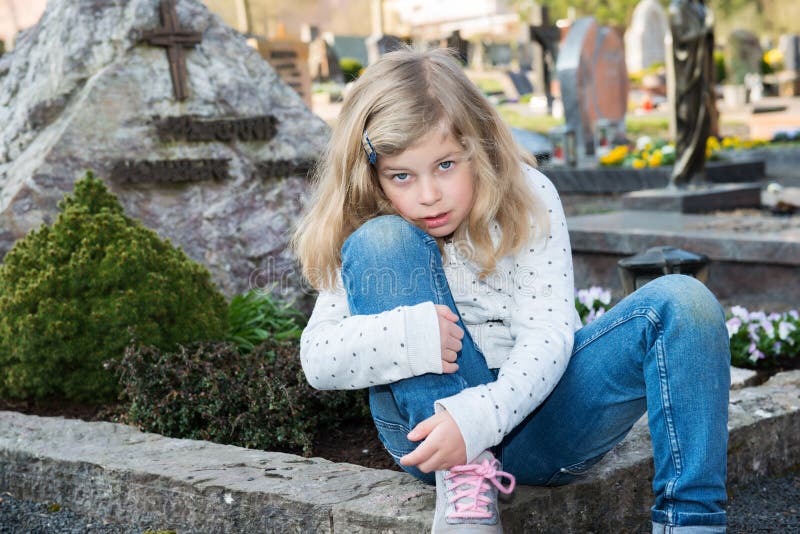 Sad girl in front of grave stock image. Image of life - 98228627