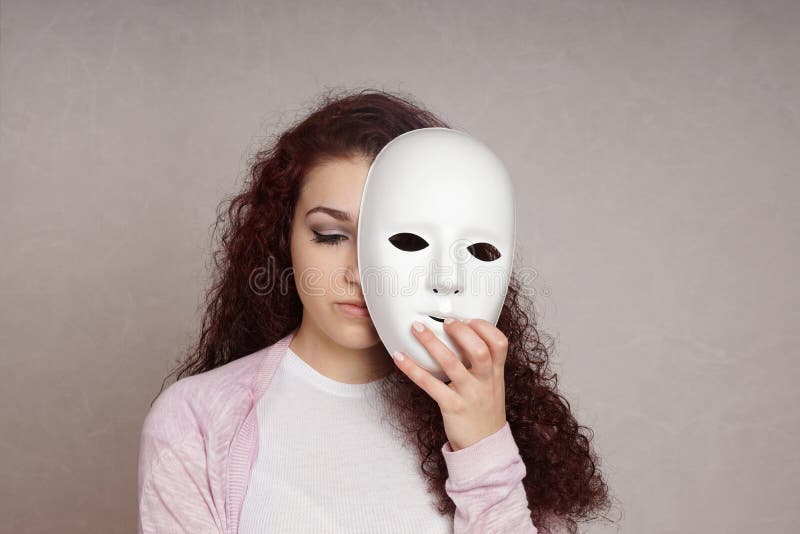 Sad girl hiding face behind mask royalty free stock photos