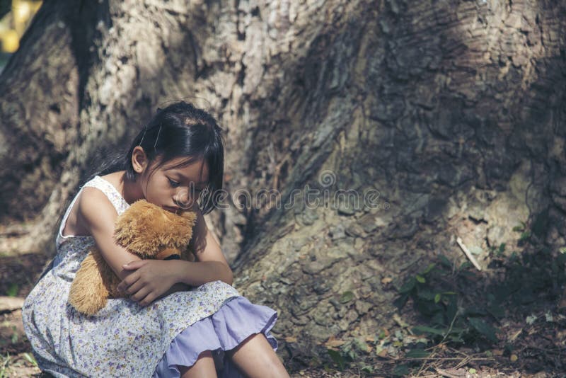 sad little girl sitting alone