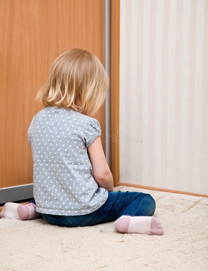 A sad girl is sitting on the floor royalty free stock photos A sad girl is sitting on the floor royalty free stock photos