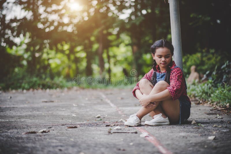 sad little girl sitting alone