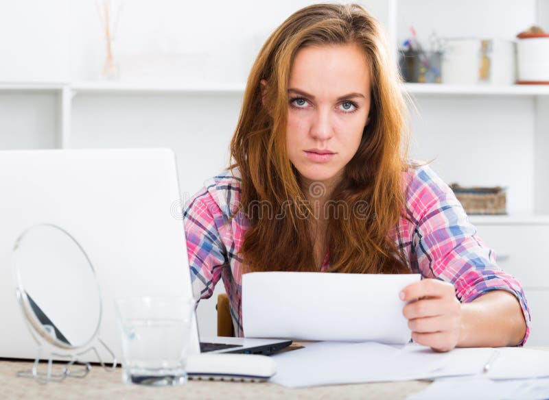 Sad girl working on laptop