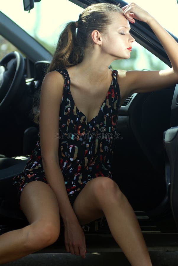 Fashionable young beautiful sad woman in a car. Fashionable young beautiful sad woman in a car