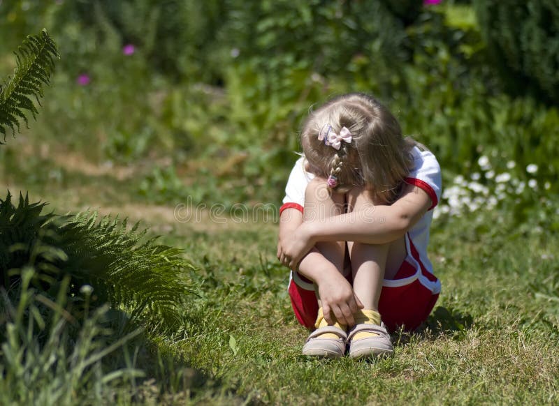 Sad little girl in garden royalty free stock photos Sad little girl in garden royalty free stock photos