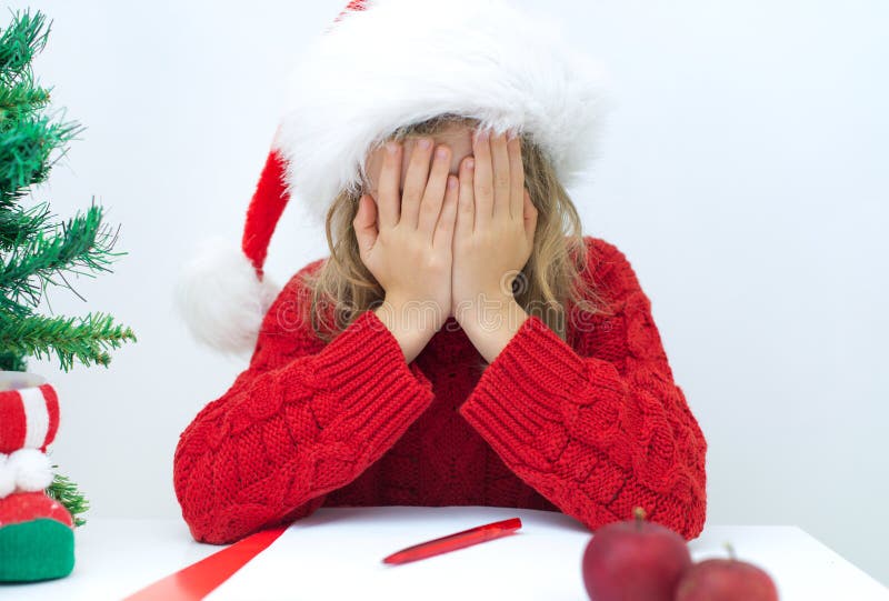 Sad little girl in red hat.