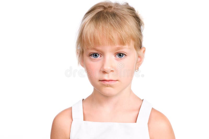 Sad little girl with serious face on white
