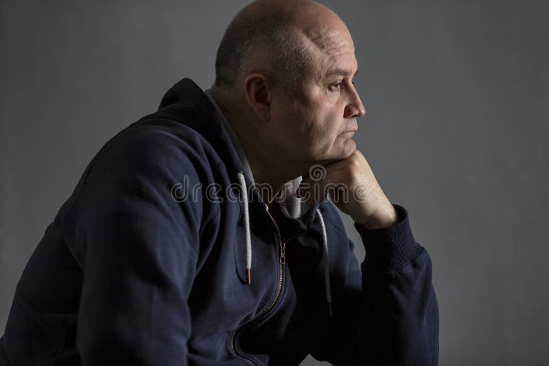 Sad middle-aged bald man. Low key royalty free stock photo Sad middle-aged bald man. Low key royalty free stock photo