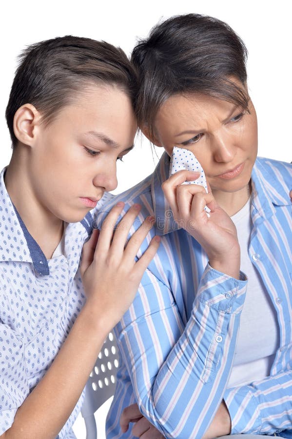 Sad mother and son posing on white background stock image Sad mother and son posing on white background stock image