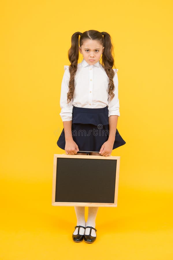 Sad news. Schoolgirl offended pupil informing you. School girl hold blank chalkboard copy space. Announcement and royalty free stock images Sad news. Schoolgirl offended pupil informing you. School girl hold blank chalkboard copy space. Announcement and royalty free stock images