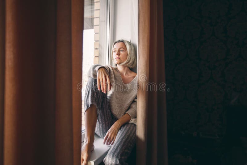 Sad pensive adult 40s woman at home