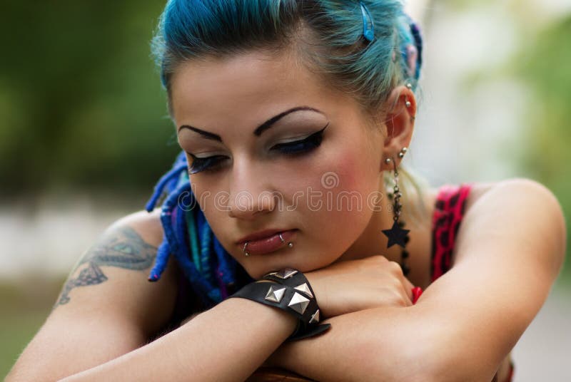 Sad punk girl posing outdoors