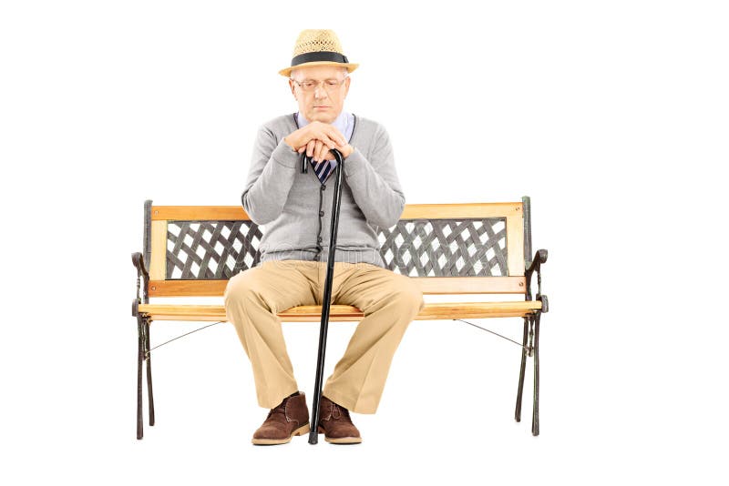 Sad senior man with a cane sitting on a wooden bench.
