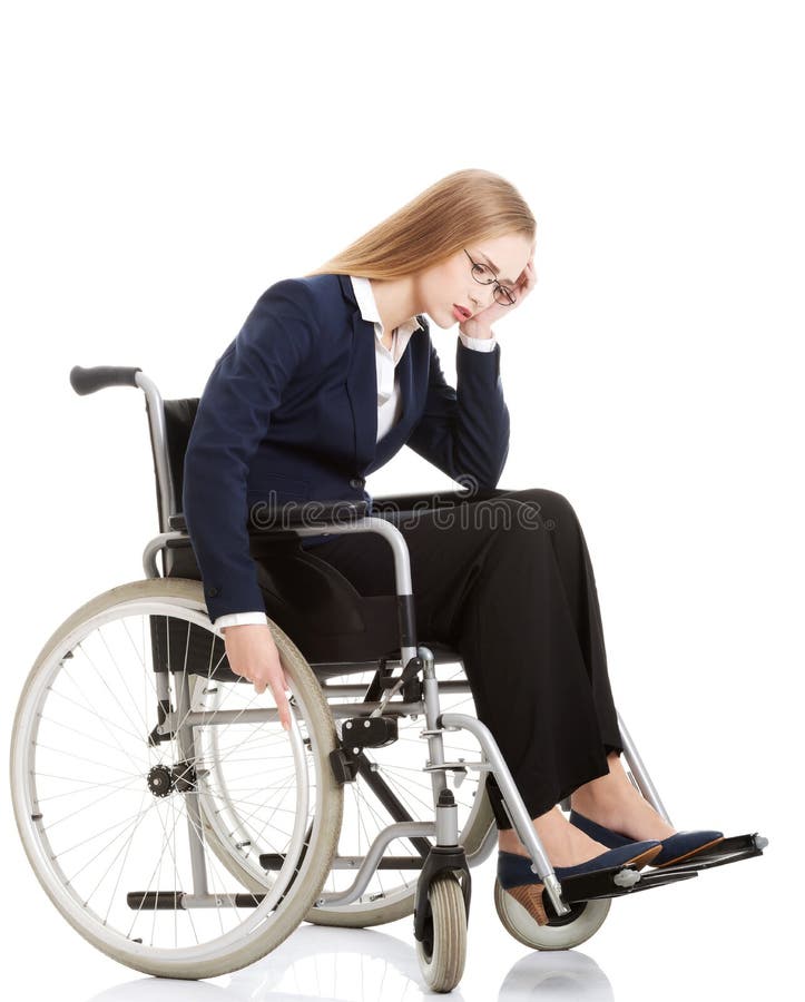 Sad, serious business woman sitting on wheelchair.