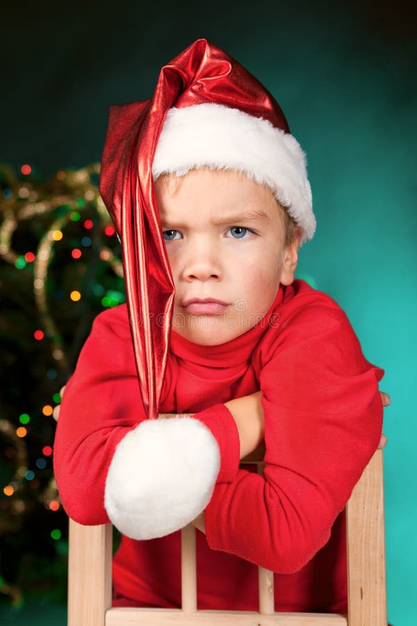 Sad small boy in santa hat