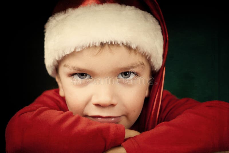 Sad small boy in santa hat